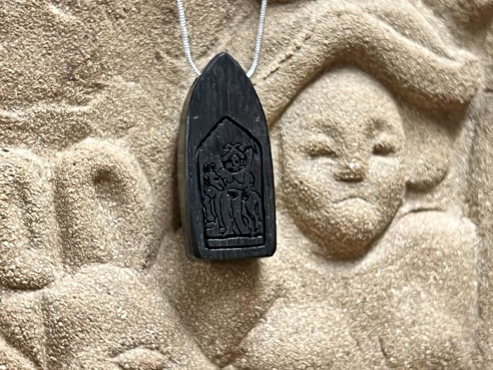 Vindolanda wood pendant with engraved image.