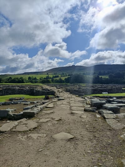 Photo of Vindolanda main street through the fort on a sunny day in August 2023.